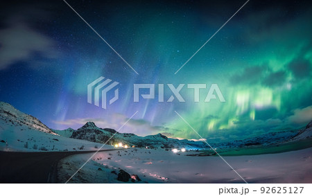 Beautiful Aurora borealis, Northern lights glowing over snow mountain and coastline in the night sky at Lofoten Islands 92625127