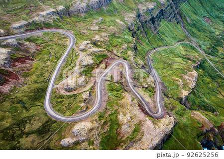 Winding gravel road through fjord of the valley in Icelandic highlands Winding gravel road through fjord of the valley in Icelandic highlands 92625256