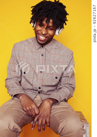 Young handsome african american guy student posing cheerful and gesturing on yellow background, lifestyle people concept close up 92627167