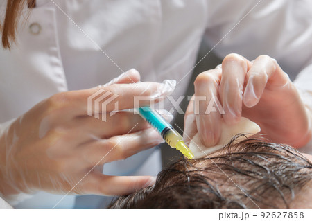 Injection plasma into head hair man cosmetologist doctor. 92627858