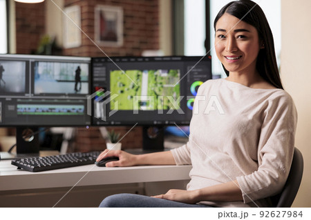 Portrait of female videographer editing movie footage on computer, working on creative software with multimedia montage. Using post production panel creating visual effects film content. Portrait of female videographer editing movie footage on computer, working on creative software with multimedia montage. Using post production panel creating visual effects film content. 92627984