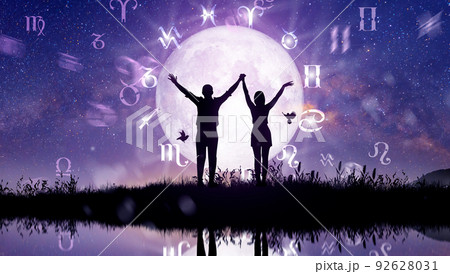 Astrological zodiac signs inside of horoscope circle. Couple singing and dancing over the zodiac wheel and milky way background. The power of the universe concept. 92628031