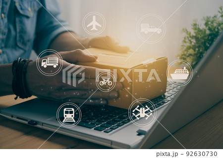 Hand of Casual Businessman Catch Parcel on Laptop and Logistic Sign in Vintage Tone Hand of Casual Businessman Catch Parcel on Laptop and Logistic Sign in Vintage Tone 92630730