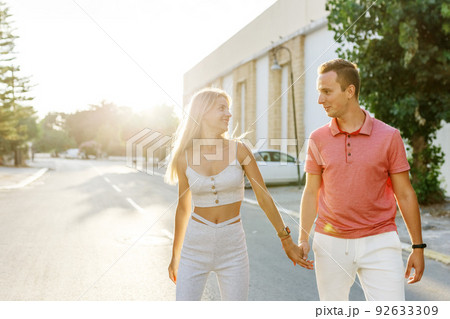 Couple has fun and laughs. Young hipster couple hugging each other in city. Summer love story, beautiful stylish young couple. Spring fashion urban concept with boyfriend and girlfriend. Select focus 92633309