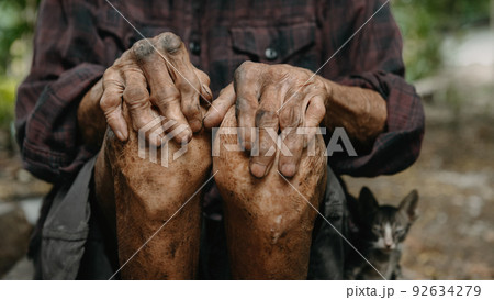 Close up of male wrinkled hands, old man is wearing. 92634279