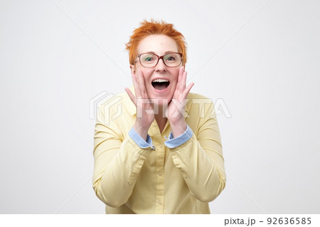 Do not tell anyone concept. Talkative prettyeuropean woman with red hair is saying secret hot braking news Do not tell anyone concept. Talkative prettyeuropean woman with red hair is saying secret hot braking news 92636585