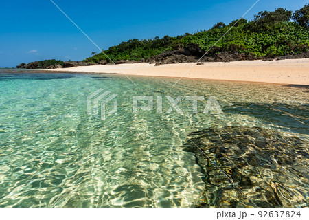 Amazing crystal clear sea waters with glistening surface, sunny day at a paradise beach. 92637824