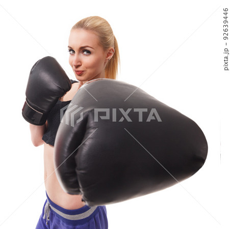Isolated portrait of athletic Asian woman in black boxing gloves. Slim athletic girl in training clothes looking at camera. Vertical concept photo of sport, boxing, victory, rivalry theme 92639446
