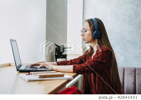 Part Time Business, Part-time job or side hustles concept. Young confident woman student in headset 92641431