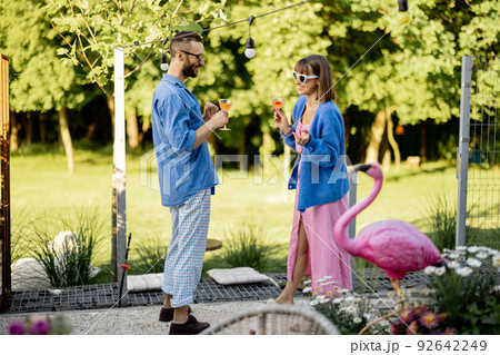 Stylish couple spend summer time at the backyard Stylish couple spend summer time at the backyard 92642249