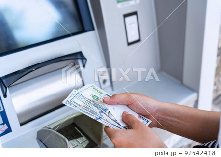Atm machine money cash. Holding american bill cash. Woman withdraw money usd hundred dollar. Us dollar bill, bank credit card. Atm machine money cash. Holding american bill cash. Woman withdraw money usd hundred dollar. Us dollar bill, bank credit card. 92642418