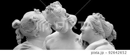 The Three Graces, Le tre Grazie. Neoclassical sculpture, in marble, of the mythological three charites isolated on black background The Three Graces, Le tre Grazie. Neoclassical sculpture, in marble, of the mythological three charites isolated on black background 92642652