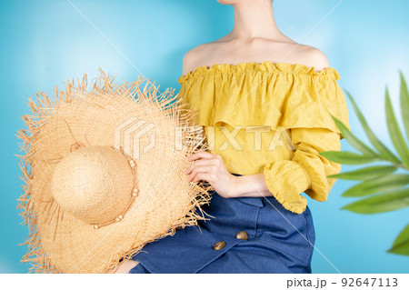 夏のイメージ　麦わら帽子を持つ女性 92647113