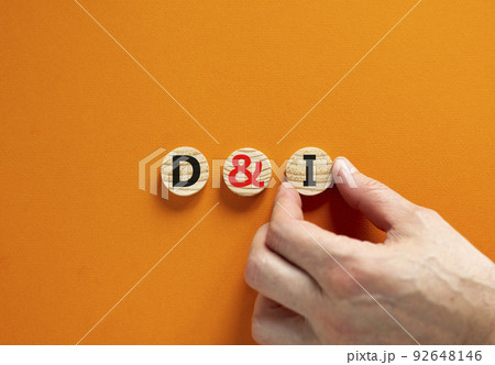 D and I, Diversity and inclusion symbol. Concept words D and I, diversity and inclusion on wooden circles on beautiful orange background. Business, D and I, diversity and inclusion concept. D and I, Diversity and inclusion symbol. Concept words D and I, diversity and inclusion on wooden circles on beautiful orange background. Business, D and I, diversity and inclusion concept. 92648146