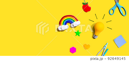 Idea light bulb with a rainbow and school supplies - flat lay Idea light bulb with a rainbow and school supplies - flat lay 92649145
