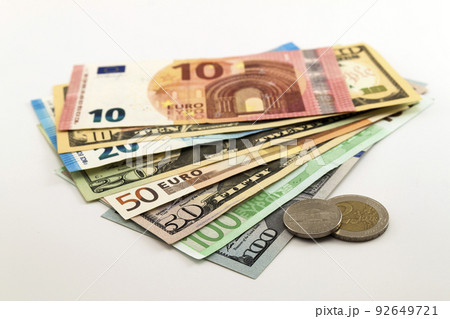 US dollar bills and Euro bills spread mixed on white background. US dollar bills and Euro bills spread mixed on white background. 92649721