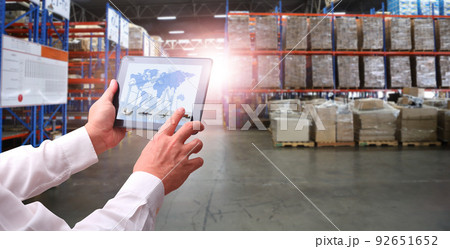Businessman control virtual interface panel of global logistics network distribution and transportation, Smart logistics, Innovation future of transport on large warehouse center background. Businessman control virtual interface panel of global logistics network distribution and transportation, Smart logistics, Innovation future of transport on large warehouse center background. 92651652