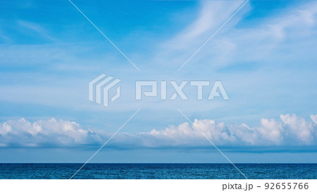 PANORAMA real photo natural cloudscape wallpaper. Beautiful white fluffy cumulus clouds summer blue sky calm sea horizon skyline. Concept relax mood, more size and tone collection in stock 92655766