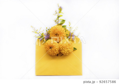 yellow flowers marigold in envelope arrangement flat lay postcard style  92657586