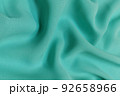 Green chiffon fabric crumpled or wavy fabric texture background. Abstract linen cloth soft waves. Silk yarn. Smooth elegant luxury cloth texture. Concept for banner or advertisement. 92658966