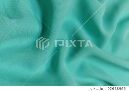 Green chiffon fabric crumpled or wavy fabric texture background. Abstract linen cloth soft waves. Silk yarn. Smooth elegant luxury cloth texture. Concept for banner or advertisement. Green chiffon fabric crumpled or wavy fabric texture background. Abstract linen cloth soft waves. Silk yarn. Smooth elegant luxury cloth texture. Concept for banner or advertisement. 92658966