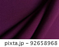 Purple crumpled or wavy fabric texture background. Abstract linen cloth soft waves. Gabardine wool fabric. Merino yarn. Smooth elegant luxury cloth texture. Concept for banner or advertisement. 92658968