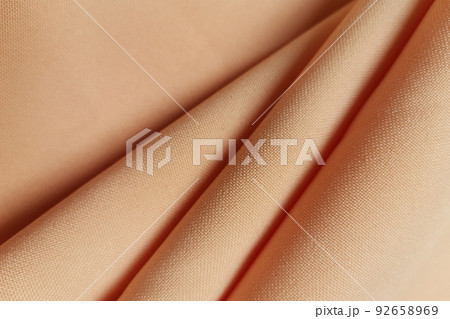 Orange crumpled or wavy fabric texture background. Abstract linen cloth soft waves. Gabardine wool fabric. Merino yarn. Smooth elegant luxury cloth texture. Concept for banner or advertisement. Orange crumpled or wavy fabric texture background. Abstract linen cloth soft waves. Gabardine wool fabric. Merino yarn. Smooth elegant luxury cloth texture. Concept for banner or advertisement. 92658969