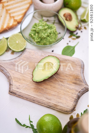 Toasts preparation - Mashed avocados in a glass bowl 92661800