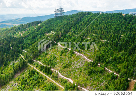Aerial view of the worlds longest 721 meter suspension footbridge Sky bridge and observation tower the Sky walk in the forest, between mountains, Dolni Morava Ski Resort, Czech Republic.  92662654