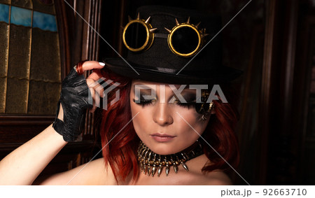 Steampunk girl hat with deep neckline, round glasses portrait Steampunk girl hat with deep neckline, round glasses portrait 92663710