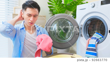 man irritated about laundry man irritated about laundry 92663770