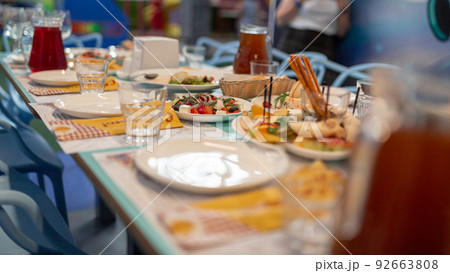 Festive table with different tasty dishes and drinks Festive table with different tasty dishes and drinks 92663808
