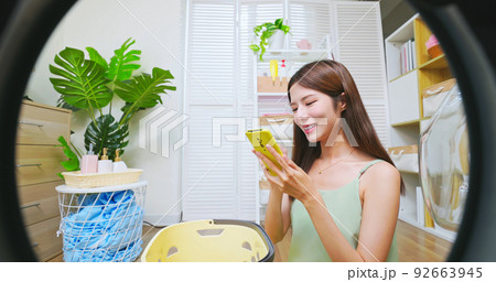 asian woman doing laundry asian woman doing laundry 92663945