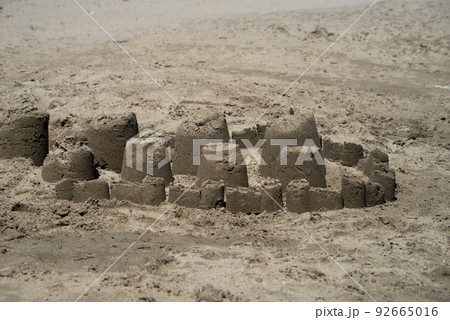 Closeup of traditional sand castle on the beach 92665016