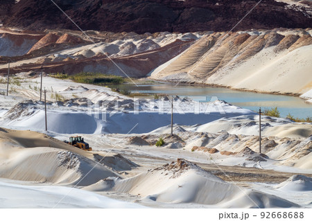 Sand extraction with machinery at quartz quarry Sand extraction with machinery at quartz quarry 92668688