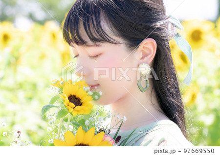 ひまわりの香りを嗅ぐ女性の美容イメージ ひまわりの香りを嗅ぐ女性の美容イメージ 92669550