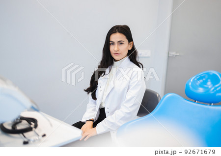 Portrait of young female dentist in office Portrait of young female dentist in office 92671679