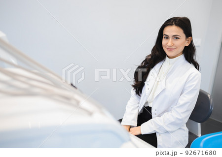 Portrait of young female dentist in office 92671680