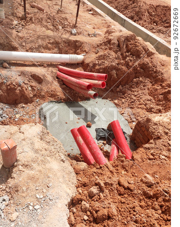 SELANGOR, MALAYSIA -AUGUST 2, 2021: Heavy-duty underground pipes lay in the ground at a construction site. this pipe will be the path to the high voltage electric cable. 92672669