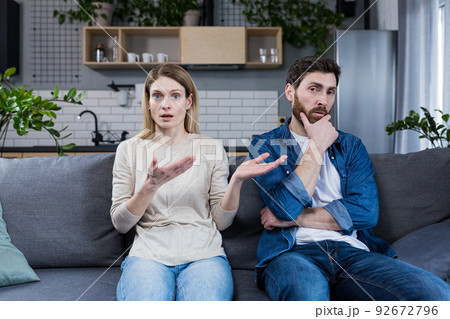 Family conflict. Young couple, family, man and woman on a reception at the psychologist. Sit on the couch, talk, gesture. discuss, argue. 92672796