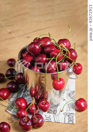 ripe cherries in a small metal bucket 92672915