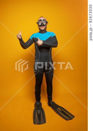 Diver man showing thumb up on yellow background, traveling concept. Diver man showing thumb up on yellow background, traveling concept. 92673030