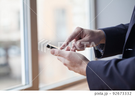 Close up of a man using mobile smart phone 92673332