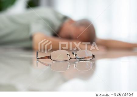 Senior Asian man falling down from chair unconsciousness alone at home. Accident in elderly man down on the floor lose consciousness or hearth attack. Elderly symptom and sudden pain. Elder care 92673454