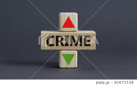 Crime rate symbol. A wooden cubes with up arrow. Wooden block with the concept word Crime. Beautiful grey table grey background. Business and crime rate concept. Copy space. 92675538
