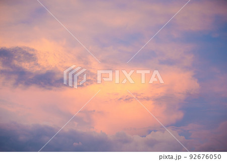 Sunset sky with colorful clouds. Blue colors merge with soft orange 92676050