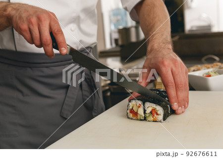 Close up of man japanese restaurant chef cooking sushi in the kitchen  92676611