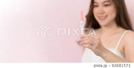 happy pregnant woman holding and showing positive pregnancy test happy pregnant woman holding and showing positive pregnancy test 92681571