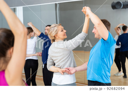 Mature dancing couple during group class Mature dancing couple during group class 92682094