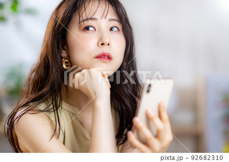 女性　スマホ　笑顔 92682310